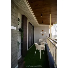 Another view of the bedroom balcony, showing the comfortable seating and the view. We design these spaces to be functional, private, and perfect for relaxation.