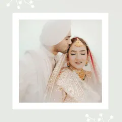 A soft, romantic portrait of the groom kissing the bride's forehead, framed by a delicate white border for an artistic touch.
