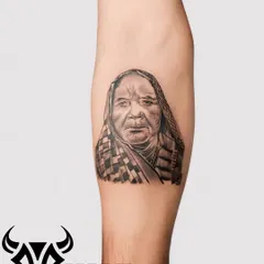 A beautiful portrait of a grandmother, capturing her kind expression in detailed black and grey. We take great pride in creating realistic memorial portraits.