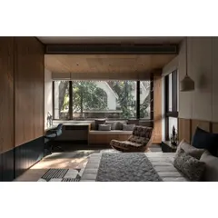 Another angle of the bedroom, showcasing the ample storage and the balance of wood tones with dark blue accents. It's a practical and stylish space for a growing child.