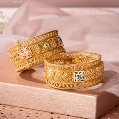 Our Svarn Meenakari Kadas are a fortress of artistry for your wrists. Crafted in 22ct gold, the surface is adorned with intricate filigree and vibrant meenakari (enamel work), translating centuries-old techniques into a masterpiece for the modern collector.