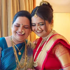 A lovely mother-daughter duo, both looking radiant in their traditional Marathi attire. It's always special to get multiple generations ready.