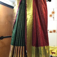 For this client, we created a unique double drape look with two sarees. This style requires careful pleating and setting, which we handled to create a seamless and artistic final appearance.