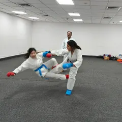 This action shot captures a moment of kumite, or sparring, between two of my students in the dojo. This practical application is key to developing reflexes, control, and confidence in one's self-defense abilities.