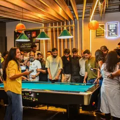 This is the energy we live for. Your whole squad, gathered around the pool table, where the competition is friendly but the bragging rights are serious. It’s way better than a house party.
