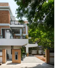 The entrance to the Ananda residence, showing the harmony between the renovated structure, lush greenery, and the new earth block extensions. We prioritize adaptive reuse, breathing new life into existing buildings with sustainable principles.