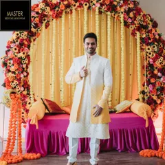 The perfect outfit for a vibrant Haldi ceremony. This client is wearing a custom Indo-Western sherwani with a yellow ombre effect, designed to complement the festive atmosphere while ensuring he looks sharp and feels comfortable.