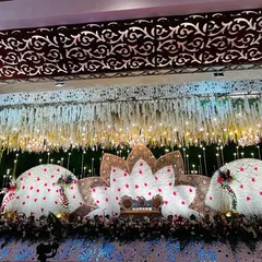 A variation of the lotus theme, this reception stage uses three large floral structures shaped like petals. The center petal forms the main backdrop for the couple's seating, creating a unique and artistic focal point for the event.