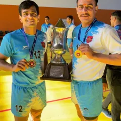 The result of all the mehnat. Two of our senior players proudly display their winners' trophy and medals after a tough championship on the mat.