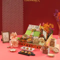 Another one of our gorgeous Teej hamper options. This one features bright, colorful dried flowers, sweet boxes, and jars of nuts, all arranged beautifully on a printed tray.
