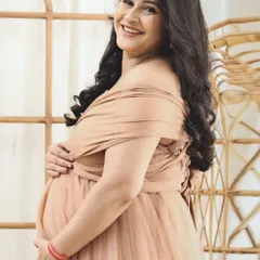 A close-up shot capturing the joyful smile of the mom-to-be. Her happiness is infectious in this beautiful, naturally lit portrait.