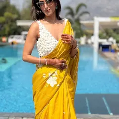 The right accessories complete any look. Here, the focus is on the textured blouse and how it contrasts with the soft organza saree. My simple white bangle and statement ring add just enough detail without overpowering the outfit.
