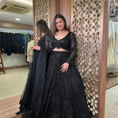 This full-length mirror shot shows the complete black sequin lehenga, a perfect outfit for any cocktail night.
