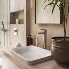 This bathroom is a serene sanctuary. I used marble-look tiles, a sleek vessel sink, and warm lighting to create a space that feels both minimalist and full of character. The addition of a plant brings a touch of nature indoors.