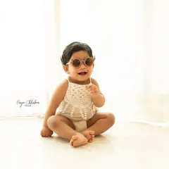 Happiness is here! A simple, bright, and airy studio shot of a happy baby in cool sunglasses. Sometimes the simplest setups allow their personality to shine the brightest.