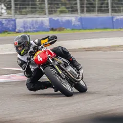 A rider leans into a corner during the RE GT Cup qualifiers. Our training helps amateur riders find their footing on the track and compete at a high level.