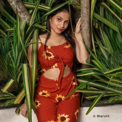 A vibrant outdoor portrait where the subject is surrounded by lush greenery, creating a fresh and lively image.