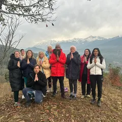 A group of students from Europe joining me for a workshop in the Himalayas. We stand together in Namaste, honoring the divine light within each of us, with the majestic mountains as our witness.