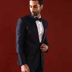 A closer look at our midnight blue patterned tuxedo jacket. The subtle texture of the fabric catches the light, offering a modern alternative to classic black while maintaining an air of formal sophistication.