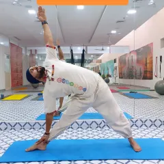 Here I am in Trikonasana (Triangle Pose). This fundamental standing pose stretches the hips, spine, and legs while strengthening the core and improving balance.