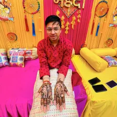 A groom showing his personalized mehendi, featuring portraits of himself and his bride. It's a modern trend that I love creating.