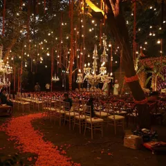 The guest's journey to the mandap should be just as beautiful as the destination. Here, a winding path of fresh marigold petals leads guests to their seats under a canopy of twinkling lights and chandeliers.