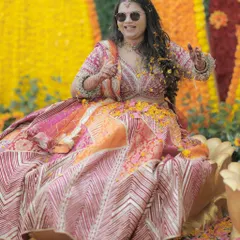 Having fun at her Haldi ceremony, this bride's makeup stays put. The look is natural and elegant, perfect for a daytime celebration.