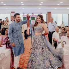 The couple's grand entrance at their engagement party. The bride's twirl shows off her stunning lehenga and her happy, carefree spirit.