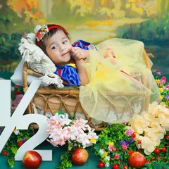 A little Snow White celebrating her half-birthday. This fairytale theme, complete with a forest backdrop and woodland creatures, is a magical way to mark the six-month milestone.