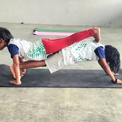 Partner acrobatics are a cornerstone of our camp, teaching children about balance, communication, and mutual support. This double plank pose showcases incredible focus and core strength from our young gymnasts.