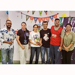 Our coaching team and parents gather for a group photo during a birthday party. These moments build a strong sense of community.