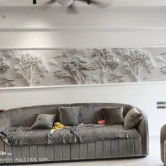 For this living room in Mulund, I installed a white 3D landscape panel. This type of textured wallpaper creates an artistic, sculptural effect that changes with the light, adding a sophisticated touch above the sofa.