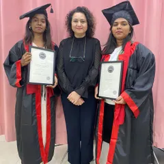 Two of our successful students displaying their CIBTAC certifications. We provide the rigorous training needed to pass these demanding international exams and become world-class professionals.