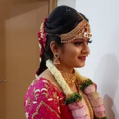 A side profile view showing the details of a traditional bridal updo. I ensure the hairstyle is secure enough to hold the head jewelry and veil in place comfortably throughout the ceremony.