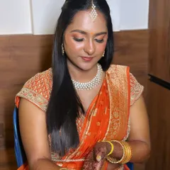 A beautiful blend of soft glam and tradition. I chose warm, peachy tones for the eyes and cheeks to complement her orange silk lehenga, creating a look that is both fresh and timeless.