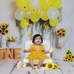 A wide shot of the complete sunflower birthday setup, showing the beautiful arrangement of balloons, flowers, and the "ONE" sign that create a festive atmosphere.