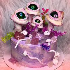 I love creepy and bizarre requests. This cake features surreal, eye-watching mushrooms on a purple marbled base, decorated with edible crystals. It's wonderfully weird.