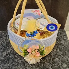This is a full view of the yellow and white jute basket hamper. It's a cheerful and charming option, perfect for a daytime event or a Mehendi function gift.