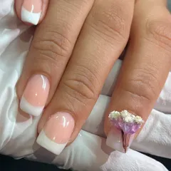 A classic French manicure with a twist. Adding a delicate bunch of 3D flowers makes the design so unique and perfect for a special occasion.