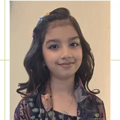 Adorable and stylish! We gave this young client soft waves, a cute braided headband with floral clips, and a touch of light, shimmery makeup.