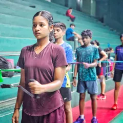 A group of young players focused during a resistance band training session. This exercise is excellent for strengthening the rotator cuff and improving shot power.