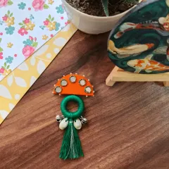 A selection of my Navratri-themed hair brooches and pins. These feature colorful fabric, mirrors, cowrie shells, and even a small bird charm, perfect for adorning a festive bun.