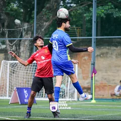 An aerial battle for the ball shows the skill and athleticism on display at our corporate football tournaments. Players give their all, making for an exciting spectator experience.
