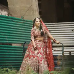 A candid moment of our bride in her red lehenga. The heavy choker and matching earrings from my collection add a touch of timeless grace to her look.