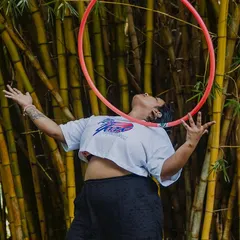 This is what it's all about. A student completely lost in the moment, finding her own unique connection with the hoop against a backdrop of bamboo. Flow is a state of mind.