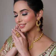 A moment of serene beauty. This shot highlights the flawless skin and the creative eye makeup, showing how the look is both festive and elegant.