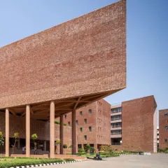 We celebrate monumental institutional architecture that shapes communities. This striking multi-utility building at Chandigarh University by Charged Voids uses a massive cantilevered brick volume to create a powerful architectural statement on campus.