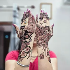 Here I created two different but coordinated back-hand designs for a client. One hand features a peacock motif, while the other has a floral mandala, showing my range in style.