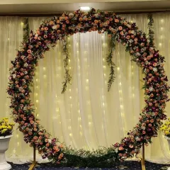 For a modern and elegant look, I created this circular floral arch using a mix of pink and white flowers. The backdrop of sheer white curtains with hanging fairy lights provides a beautiful, soft glow perfect for reception photos.