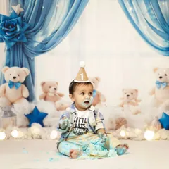 A close-up of the birthday boy enjoying his first taste of cake. The soft, dreamy background with fairy lights and teddy bears makes the moment even more magical. We handle all the decorations for the pre-birthday celebration.